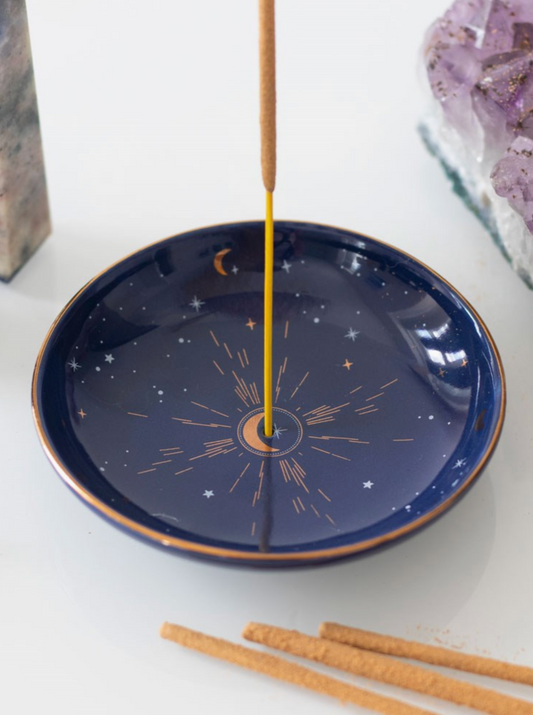 This modern incense stick holder features a starry sky design accented by gold foil details. Simply place a smoking incense stick in the centre of the holder or use to store small trinkets on a vanity or bedside table.&nbsp;