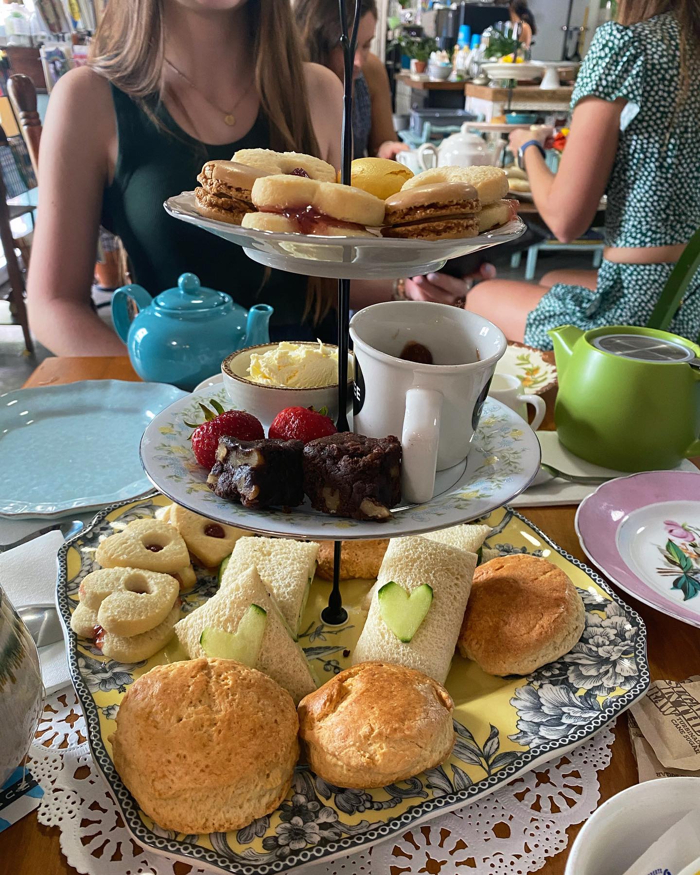3 tier plates with cookies, scones, and finger sandwiches.